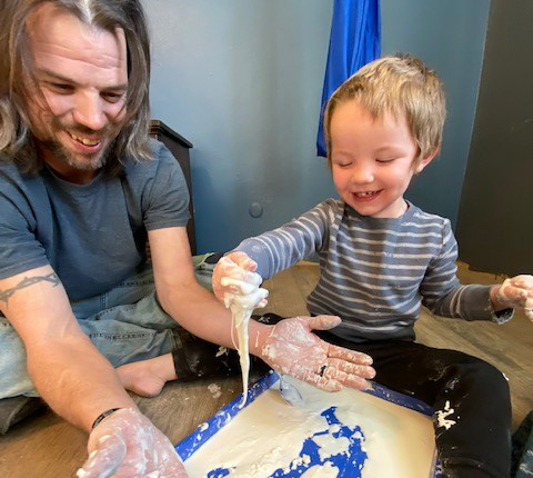 Man and toddler with sensory play